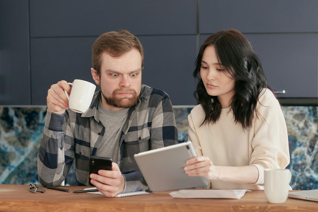 Couple looking at painting estimate shocked at the price.